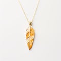 Goldplated Leaf Necklace With Feather Rendering And Maori Art