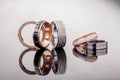 Silver, gold, platinum rings of different styles on the gray background of reflections