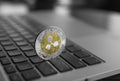 Silver gold ripple coin on a laptop keyboard closeup. Blockchain mining. Digital money and virtual cryptocurrency Royalty Free Stock Photo