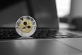 Silver gold ripple coin on a laptop keyboard closeup. Blockchain mining. Digital money and virtual cryptocurrency Royalty Free Stock Photo