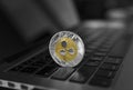 Silver gold ripple coin on a laptop keyboard closeup. Blockchain mining. Digital money and virtual cryptocurrency Royalty Free Stock Photo