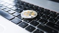 Silver gold ripple coin on a laptop keyboard closeup. Blockchain mining. Digital money and virtual cryptocurrency Royalty Free Stock Photo