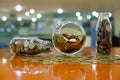 Silver and gold stacked coins in three glass jars on wooden table with bokeh background, Business and finance, Thai Baht currency Royalty Free Stock Photo