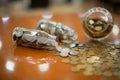 Silver and gold stacked coins in three glass jars on wooden table with bokeh background, Business and finance, Thai Baht currency Royalty Free Stock Photo