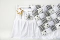 Silver and gold star shaped pillows and patchwork comforter on a white baby cot Royalty Free Stock Photo