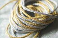 Silver and gold twine on silverbackground Royalty Free Stock Photo