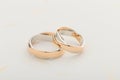 Silver and gold wedding rings on white background Royalty Free Stock Photo