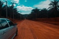 gray color car on the red soild road ,Thailand countrysid nice view