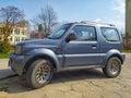 Silver grey small 4WD car Suzuki Jimny parked