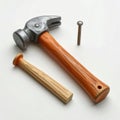 Silver Hammer with Brown Wooden Handle and Nail on White Background Royalty Free Stock Photo