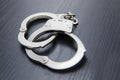 Silver handcuffs detaining crime prisoners Royalty Free Stock Photo