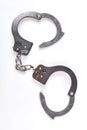 Silver handcuffs on white background.