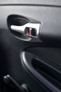 Silver handle, opening the car door closeup on the inside of the lining of the vehicle doors Royalty Free Stock Photo