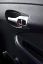 Silver handle, opening the car door closeup on the inside of the lining of the vehicle doors Royalty Free Stock Photo