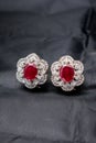 Silver handmade flower shaped earring with a red ruby Royalty Free Stock Photo