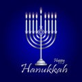 Silver hanukkah menorah hanukkiah with nine burning candles on a blue background