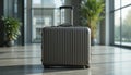 Silver hard-shell suitcase with vertical ridges and an extended black handle Royalty Free Stock Photo