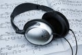 Silver headphones on sheet music Royalty Free Stock Photo