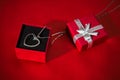 Silver heart pendant in a red gift box Royalty Free Stock Photo