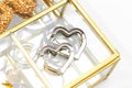Silver heart shaped earrings on glass jewelry box