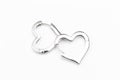 Silver heart shaped earrings isolate on white Royalty Free Stock Photo