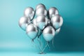 Silver helium balloons in a bundle on a blue background