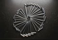 Silver hex keys (Allen wrenches) are arranged in a circular pattern on a dark, textured Royalty Free Stock Photo