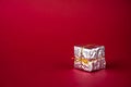 Silver holiday gift box on a red background. Copy space Royalty Free Stock Photo