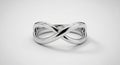 A silver infinity symbol sculpture on a plain white background. The design consists of Royalty Free Stock Photo