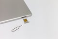 Silver inverted tablet. The SIM card tray is open. Royalty Free Stock Photo