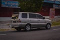 Silver Isuzu panther family car driving fast on the road