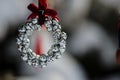 Silver Jingle Bell Wreath Christmas Ornament Decorating an Outdoor Tree Royalty Free Stock Photo