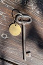 Old key with blank tag wooden background. Space for text. Rustic texture. Retro style. Vintage object Royalty Free Stock Photo