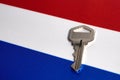 Silver key on the flag of Netherlands. Close-up, copy space