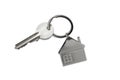 Silver key house with house shaped metal keychain on white background. Royalty Free Stock Photo