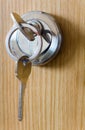 The silver key is inserted into the keyhole. Close-up. Royalty Free Stock Photo