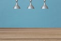 Silver lamps on the ceiling and a backdrop on a blue concrete wa