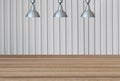 Silver lamps on the ceiling and a backdrop on a white Metal Sheet wall with brown wood floor.