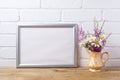 Silver landscape frame mockup with chamomile and purple flowers