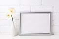 Silver landscape frame mockup with soft yellow orchid in vase