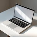 Silver Laptop with Blank Screen on White Table with Sunlight Shadows computer notebook Royalty Free Stock Photo