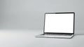 Silver laptop computer with a blank white screen open on a light gray surface with copy space Keywords: laptop Royalty Free Stock Photo