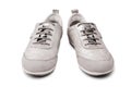 Silver leather sneakers white background isolated close up front view, stylish light gray suede gumshoes, pair of beige shoes Royalty Free Stock Photo