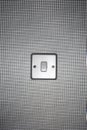 Silver light switch on wallpaper covered wall Royalty Free Stock Photo