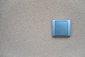 Silver light switch on yellow outdoor wall Royalty Free Stock Photo