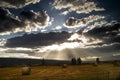 Silver-lined clouds over field Royalty Free Stock Photo