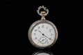 Silver mechanical antique pocket watch on black isolated background. Retro pocketwatch with second, minute and hour hand