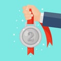 Silver medal with red ribbon for second place in hand. Trophy, winner award isolated on background. Badge icon. Sport, business