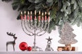 Silver menorah  Christmas decorations and dreidels with symbols He  Nun  Pe  Gimel near fir tree branches. Hanukkah symbol Royalty Free Stock Photo
