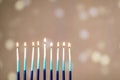 A silver menorah for the Jewish holiday Hanukkah with eight unlit candles